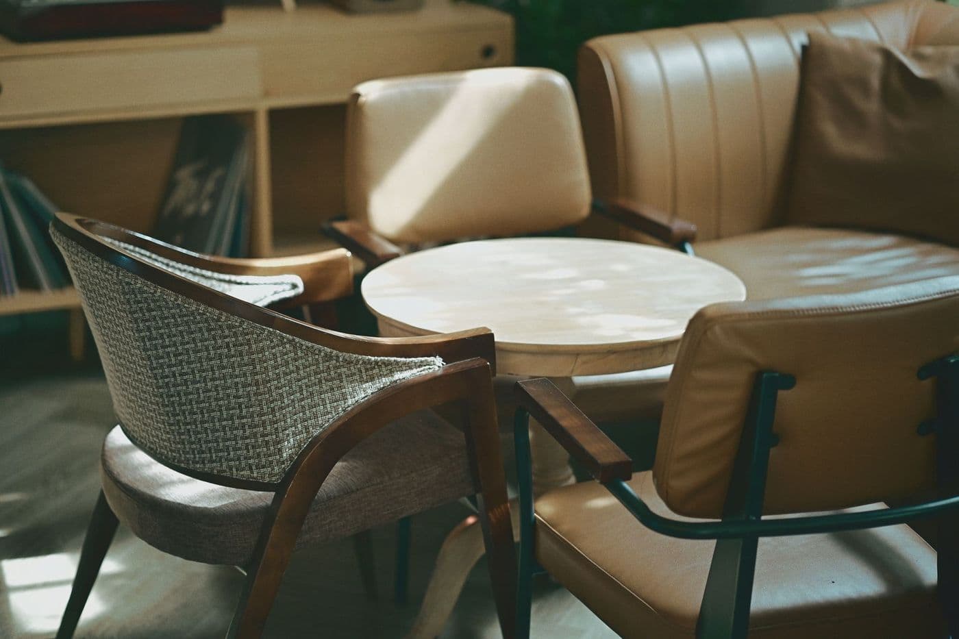 Mid-century modern chairs and sofa in a sunlit living room setting.